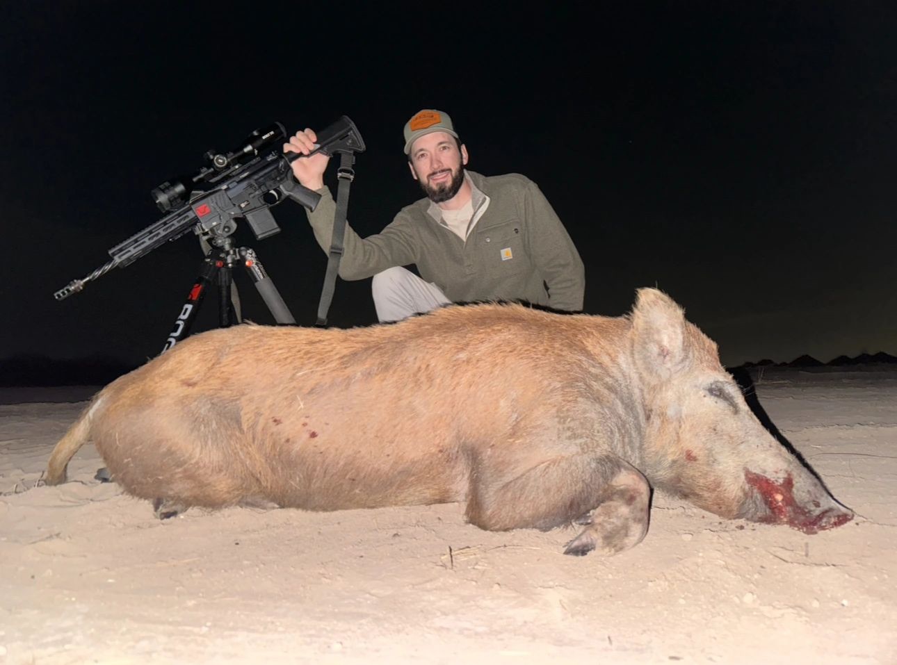Hunter with a hog at night
