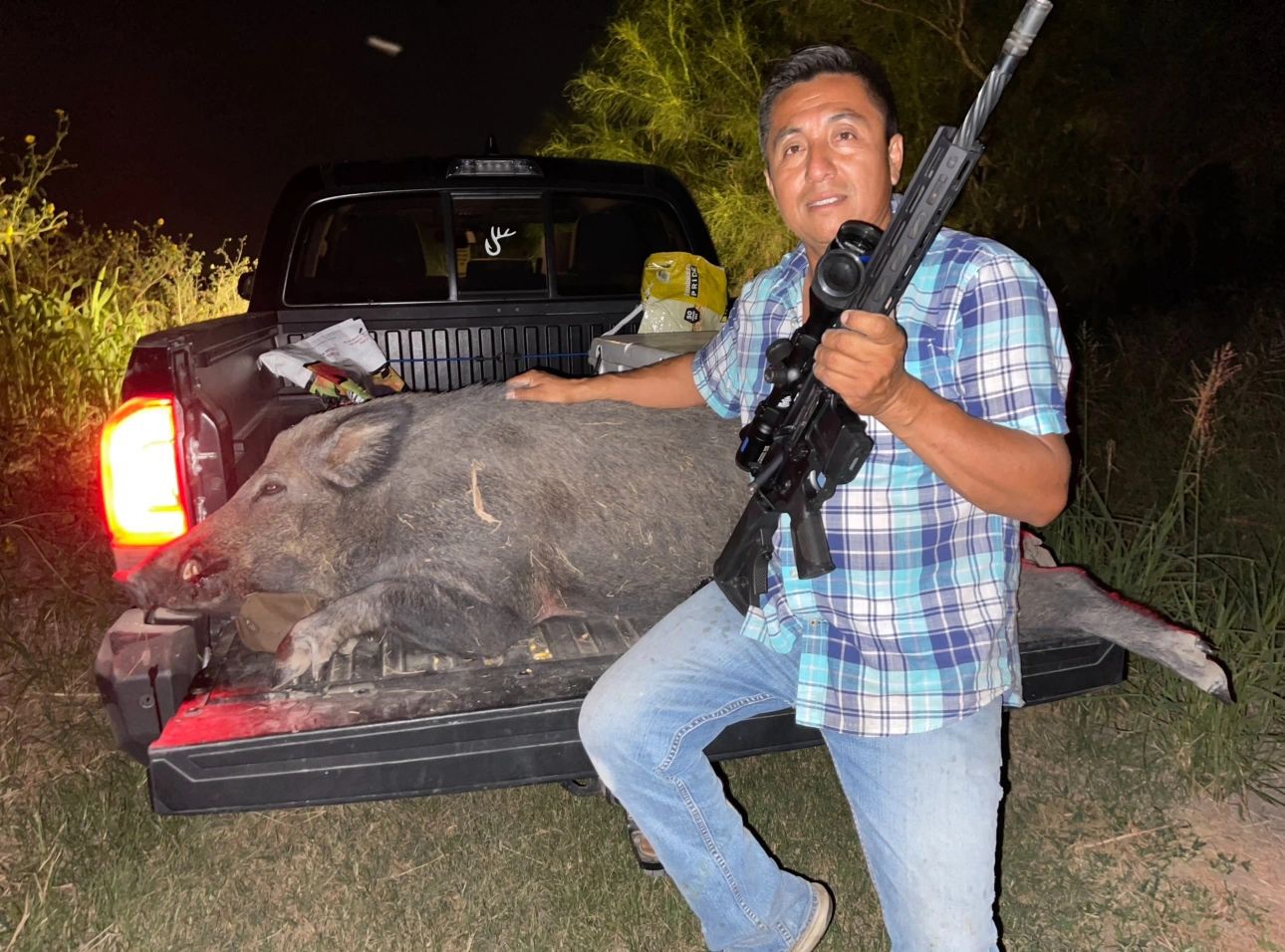 Hunter with a hog by the truck